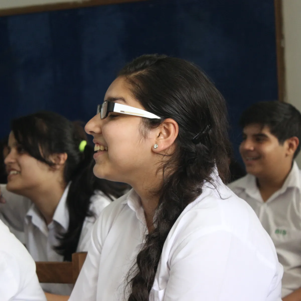 A student smiling in class during a Brainwiz session