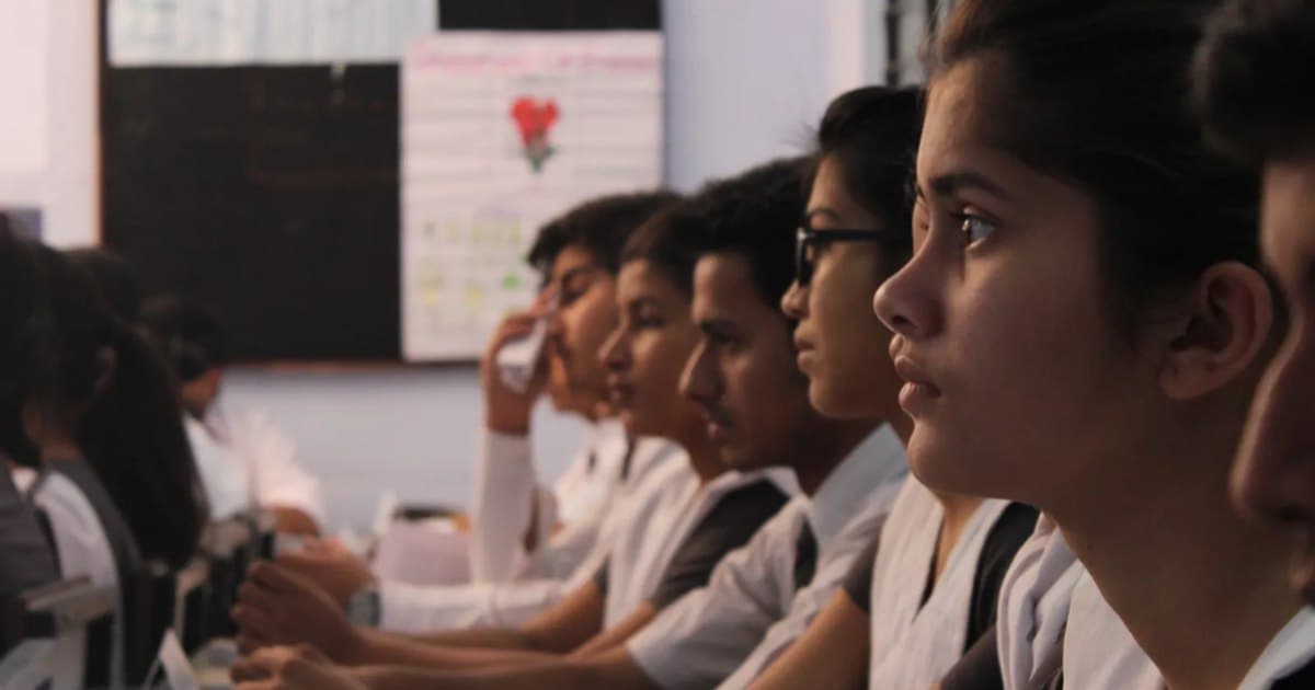 Students listening intently in a classroom, deep in thought